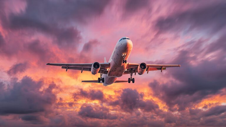 airplane-taking-off-during-sunset-with-dramatic-sk